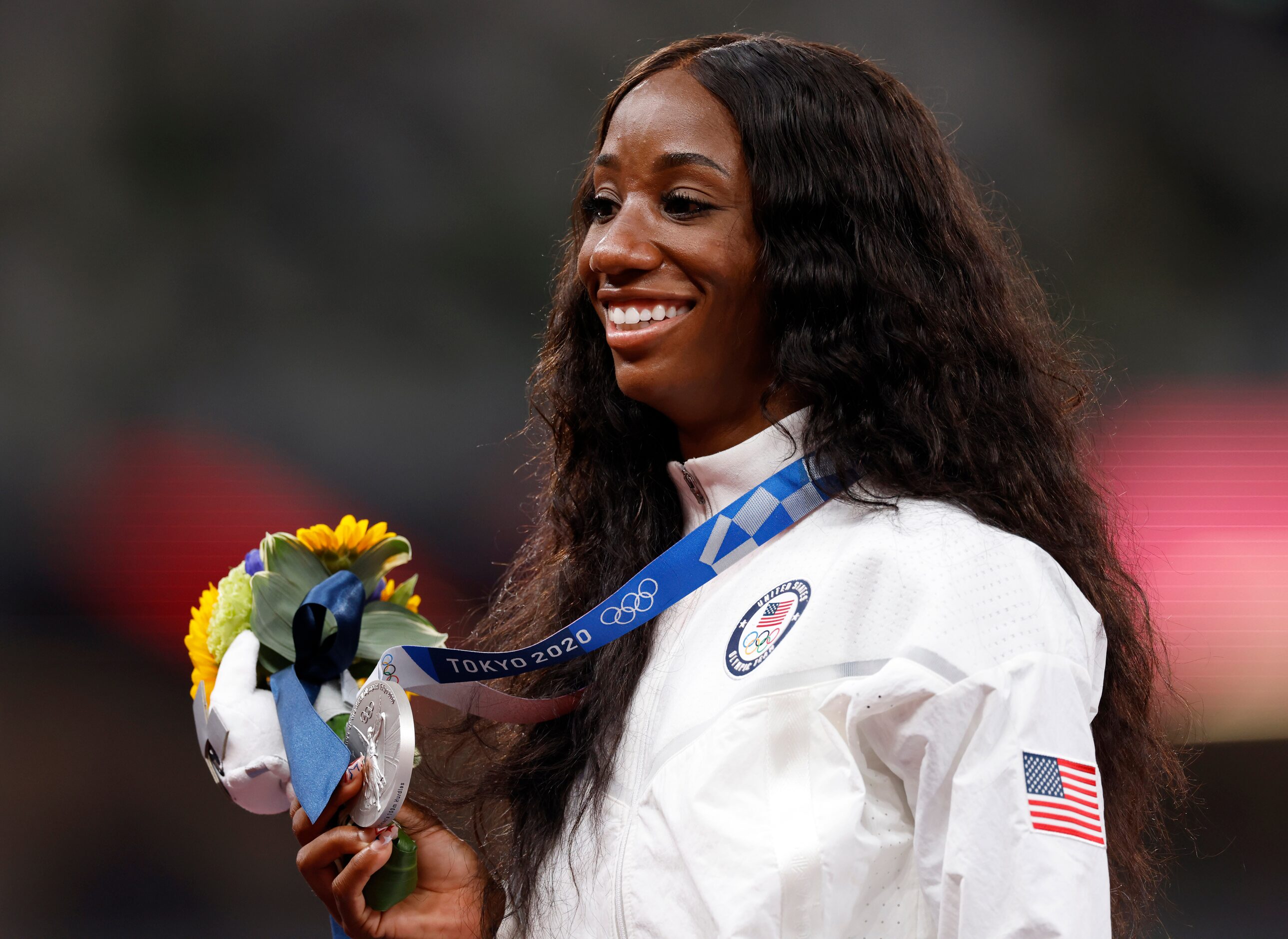 USA’s Kendra Harrison poses for photographers after receiving her  silver medal in the 100...