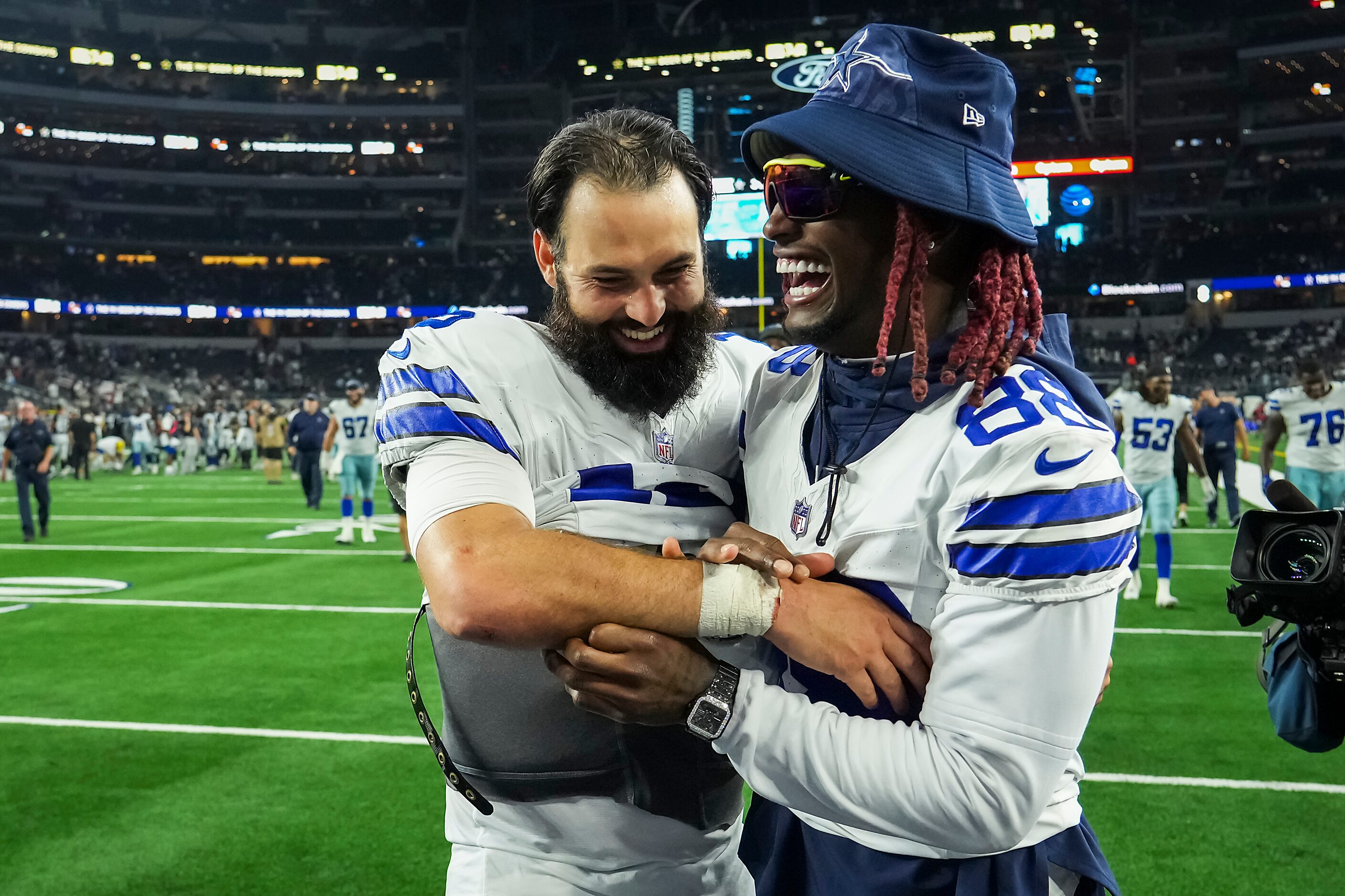 Dallas Cowboys quarterback Will Grier (15) celebrates wide receiver CeeDee Lamb (88) after...