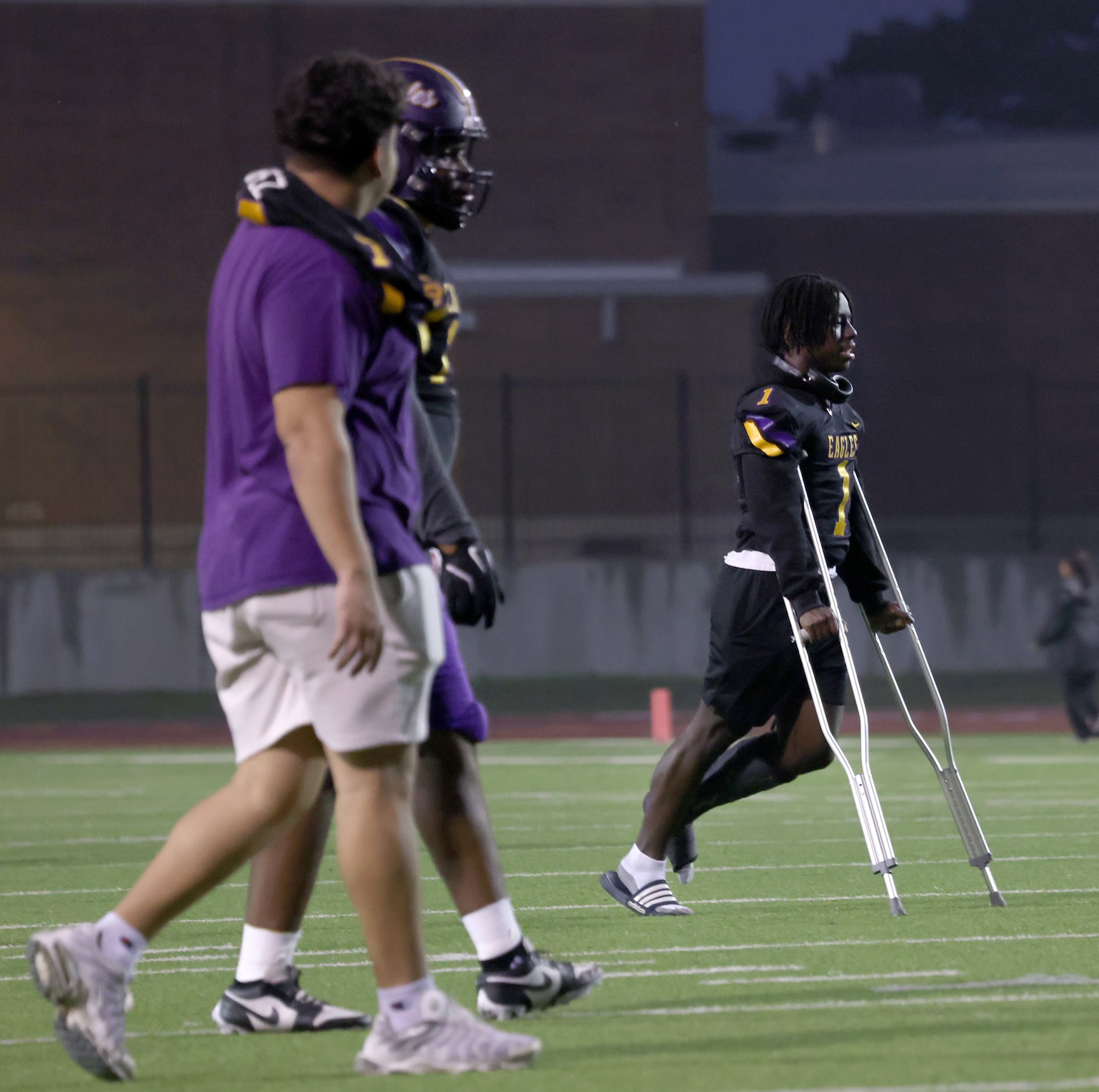 Injured Richardson running back Jaden Pope (1) exits the field with the assistance of...