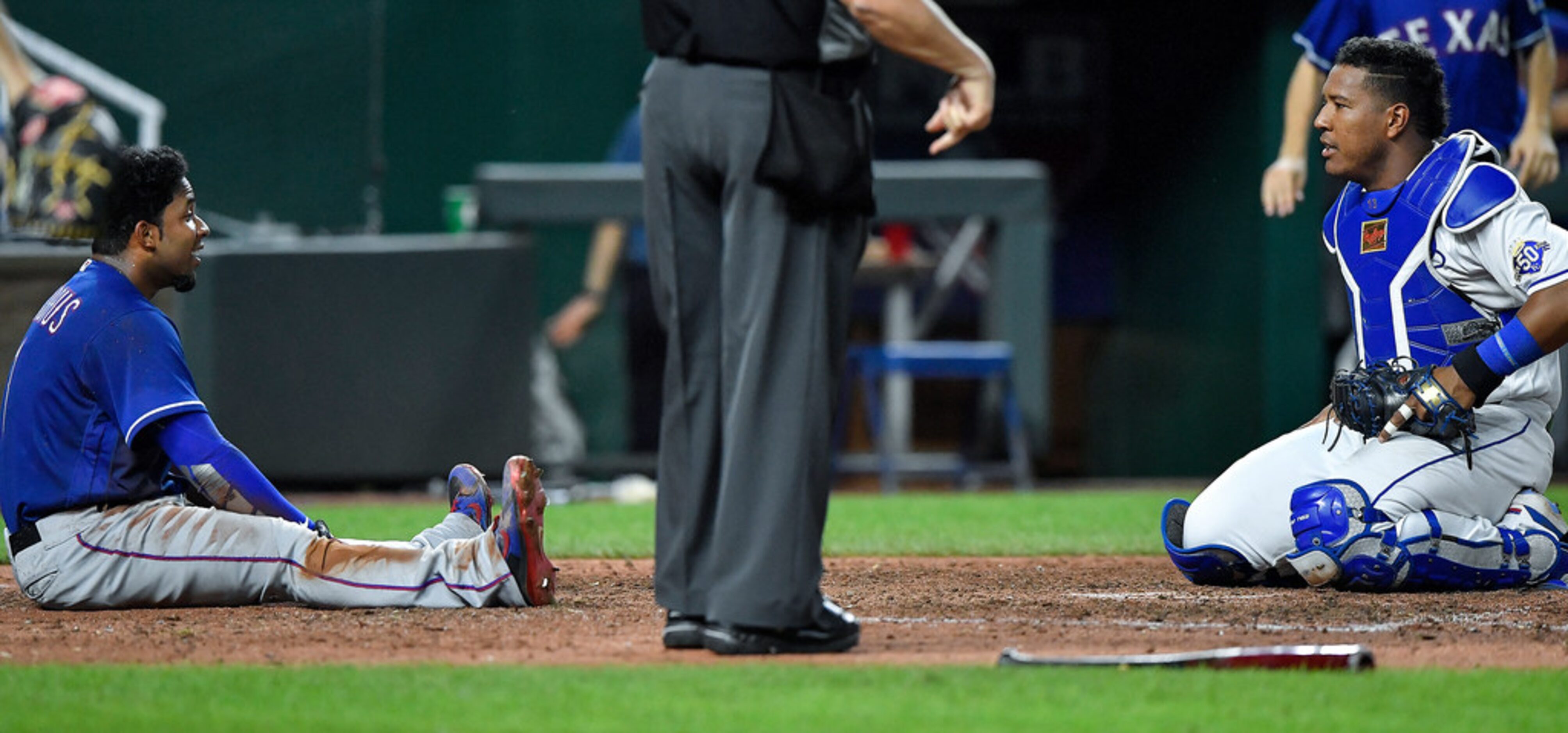 Kansas City Royals catcher Salvador Perez, right, and the Texas Rangers' Elvis Andrus stare...