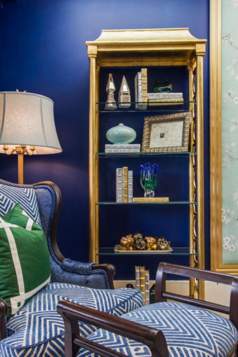 IBB Design Fine Furnishings of Frisco created drama with deep-blue walls complemented by...