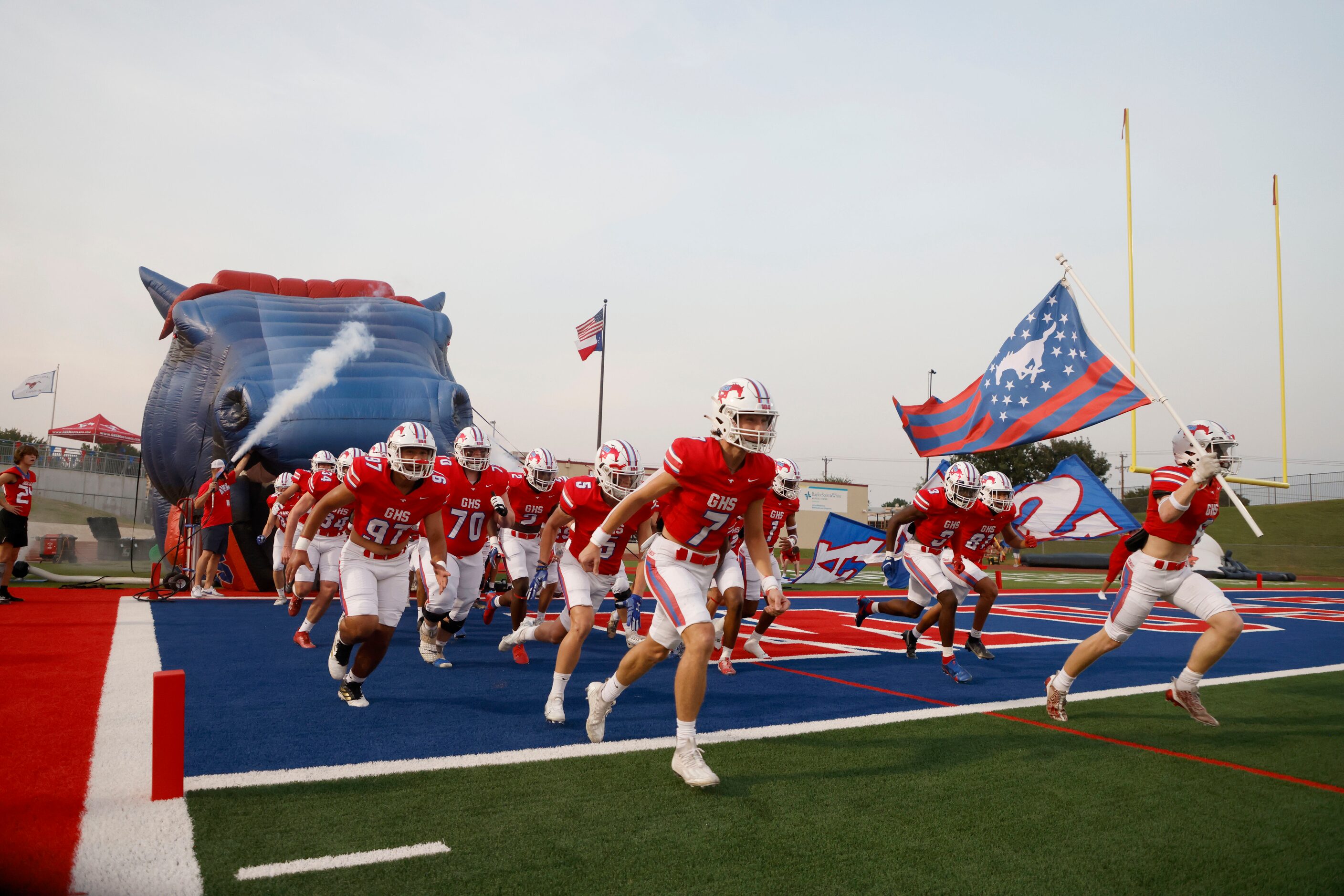 The Grapevine football team rushes the field prior to playing Frisco Wakeland during a high...