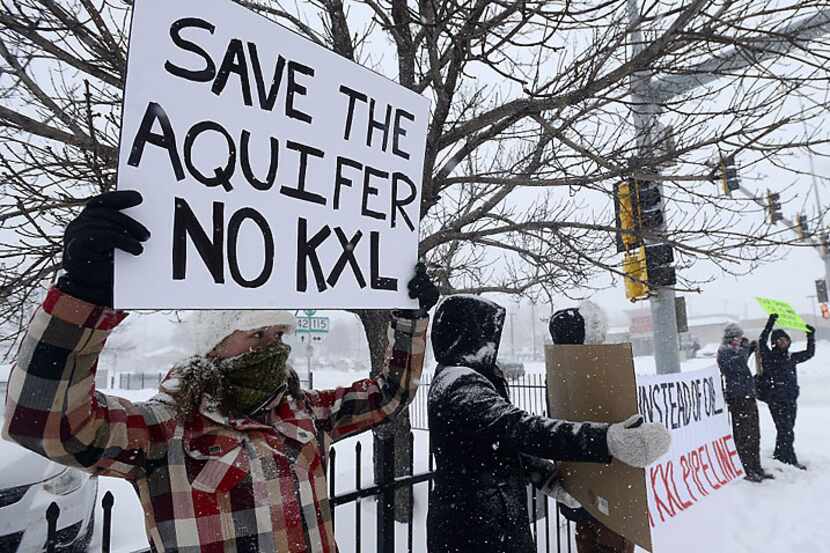 Demonstrators protest the Keystone XL pipeline in Sioux Falls, S.D., in conjunction with the...