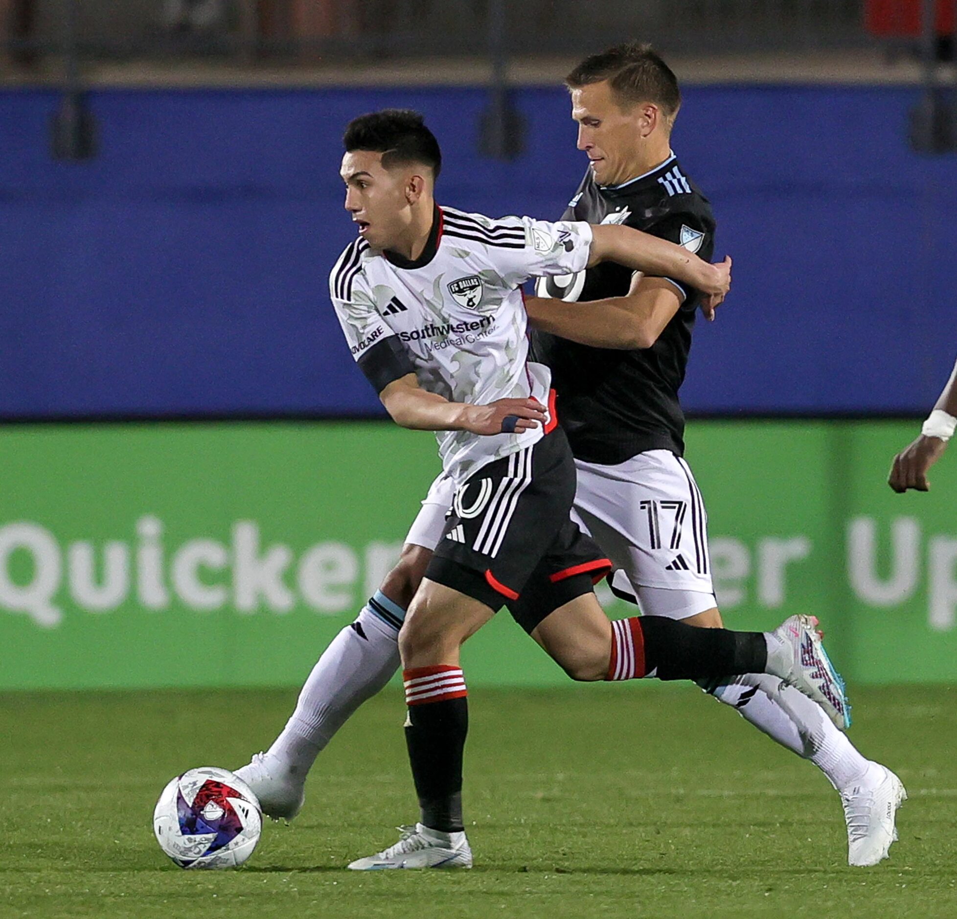 FC Dallas attacker Alan Velasco, (left) tries to take to ball away from Minnesota United...