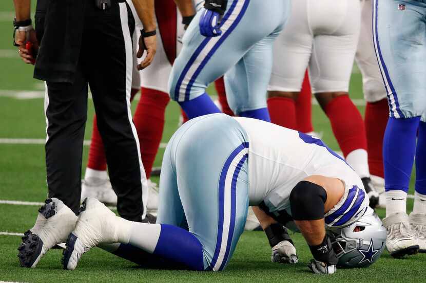 Dallas Cowboys offensive guard Zack Martin (70) struggles to get up after getting injured in...