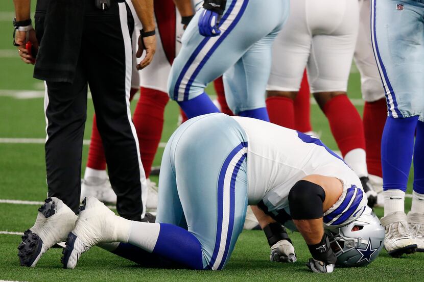Dallas Cowboys offensive guard Zack Martin (70) struggles to get up after getting injured in...