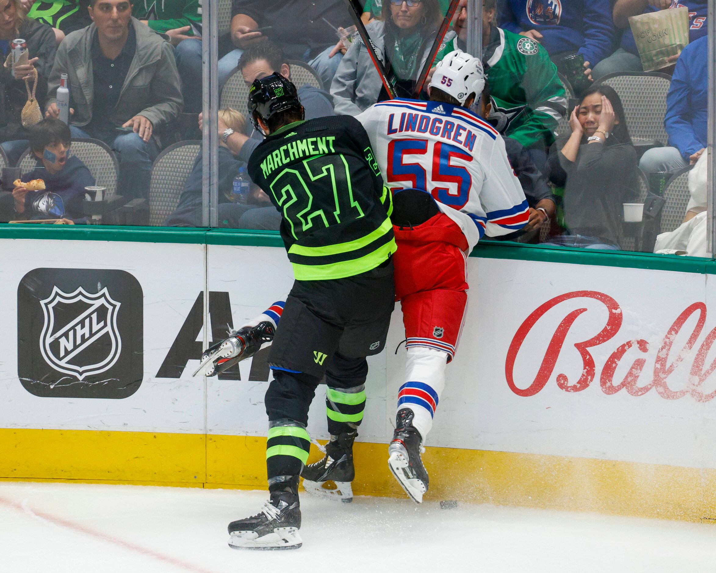 Dallas Stars left wing Mason Marchment (27) checks New York Rangers defenseman Ryan Lindgren...