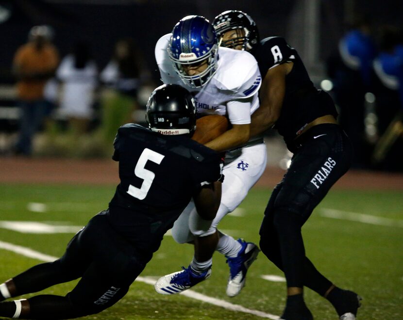 Fort Worth Nolan QB Luke Macias (2) is sacked by Bishop Lynch defenders Gabriel Murphy (5)...