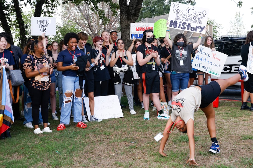 A Grapevine High School student performs a cartwheel in front of other students on Aug. 26,...