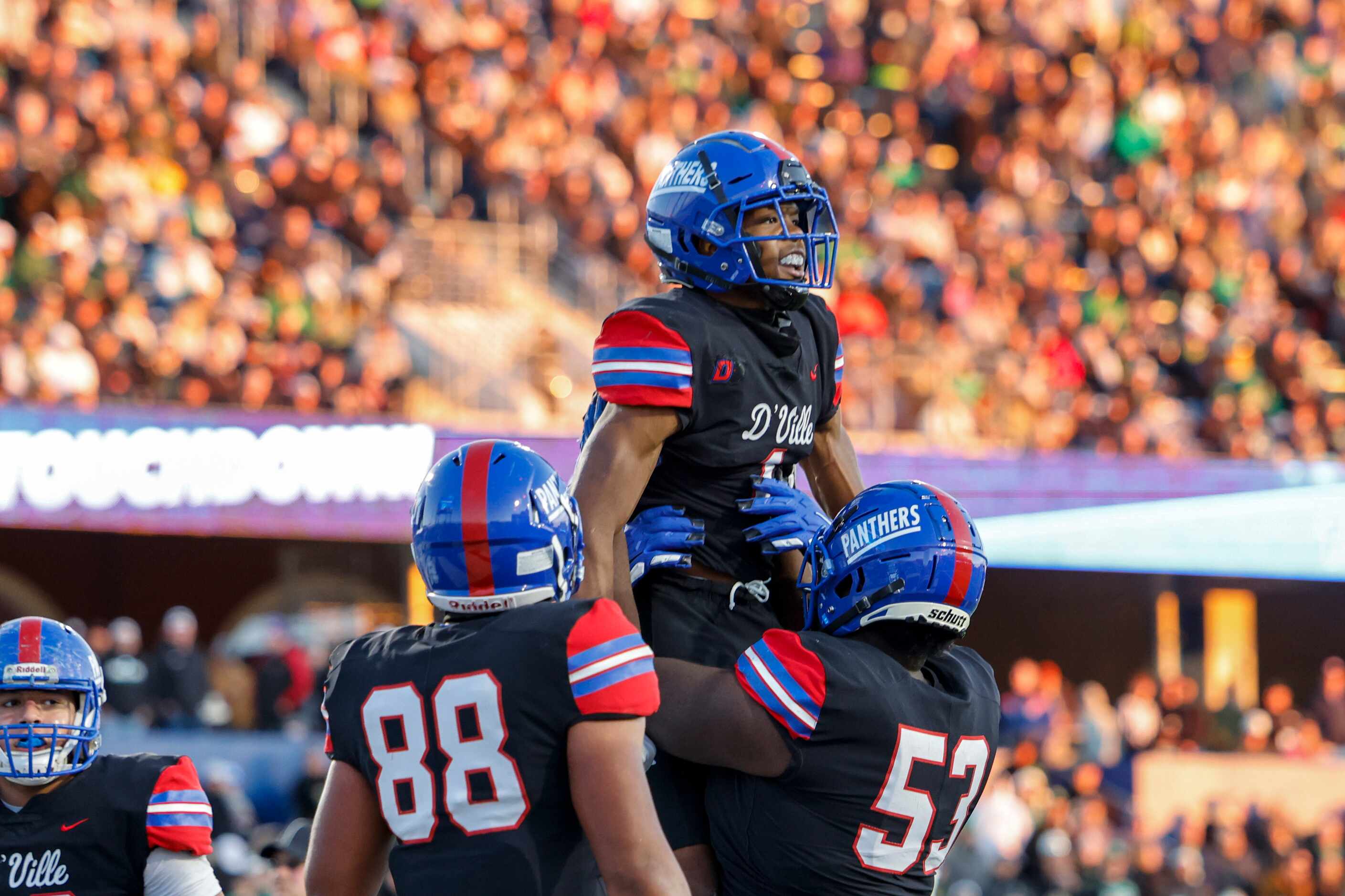 Duncanville offensive lineman Jaylen Early (53) lifts wide receiver Lontrell Turner (1)...