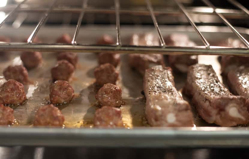 Meatballs and ribs cook in the oven for Julian Barsotti's Sunday gravy.