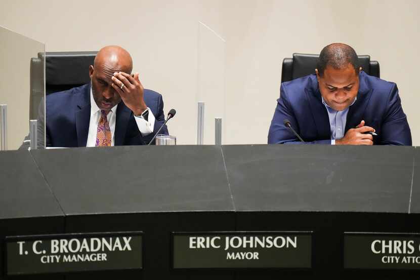 Dallas City Manager T.C. Broadnax (left) and Mayor Eric Johnson listen to public comment...