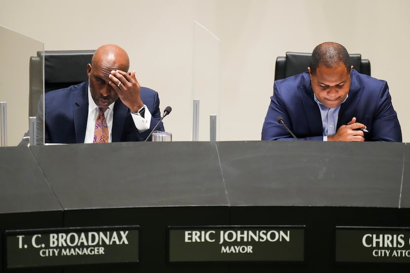 Dallas City Manager T.C. Broadnax, left, and Mayor Eric Johnson listen to public comment...
