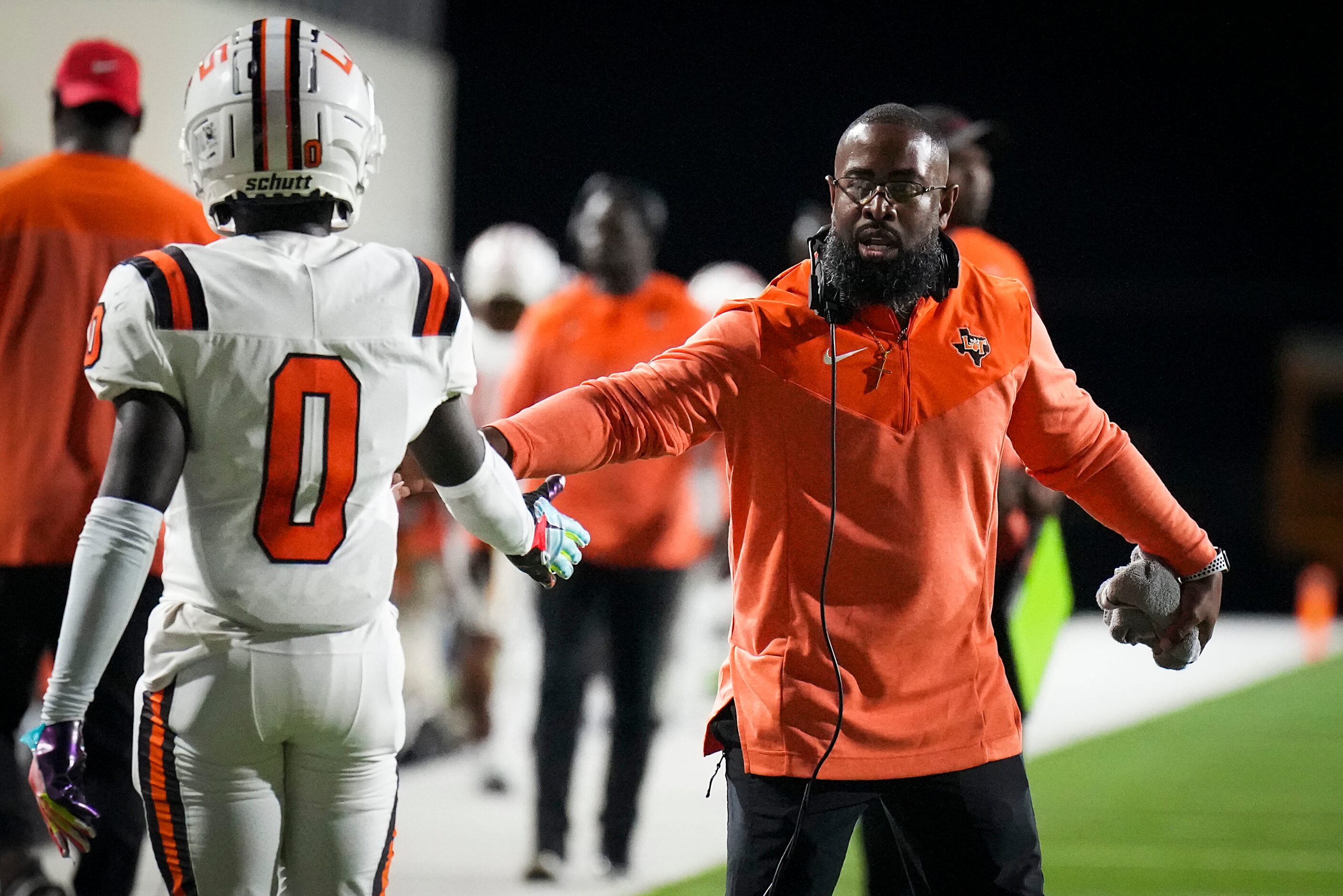 Lancaster head coach Leon Paul III congratulats wide receiver Ti'Erick Martin (0) after a...