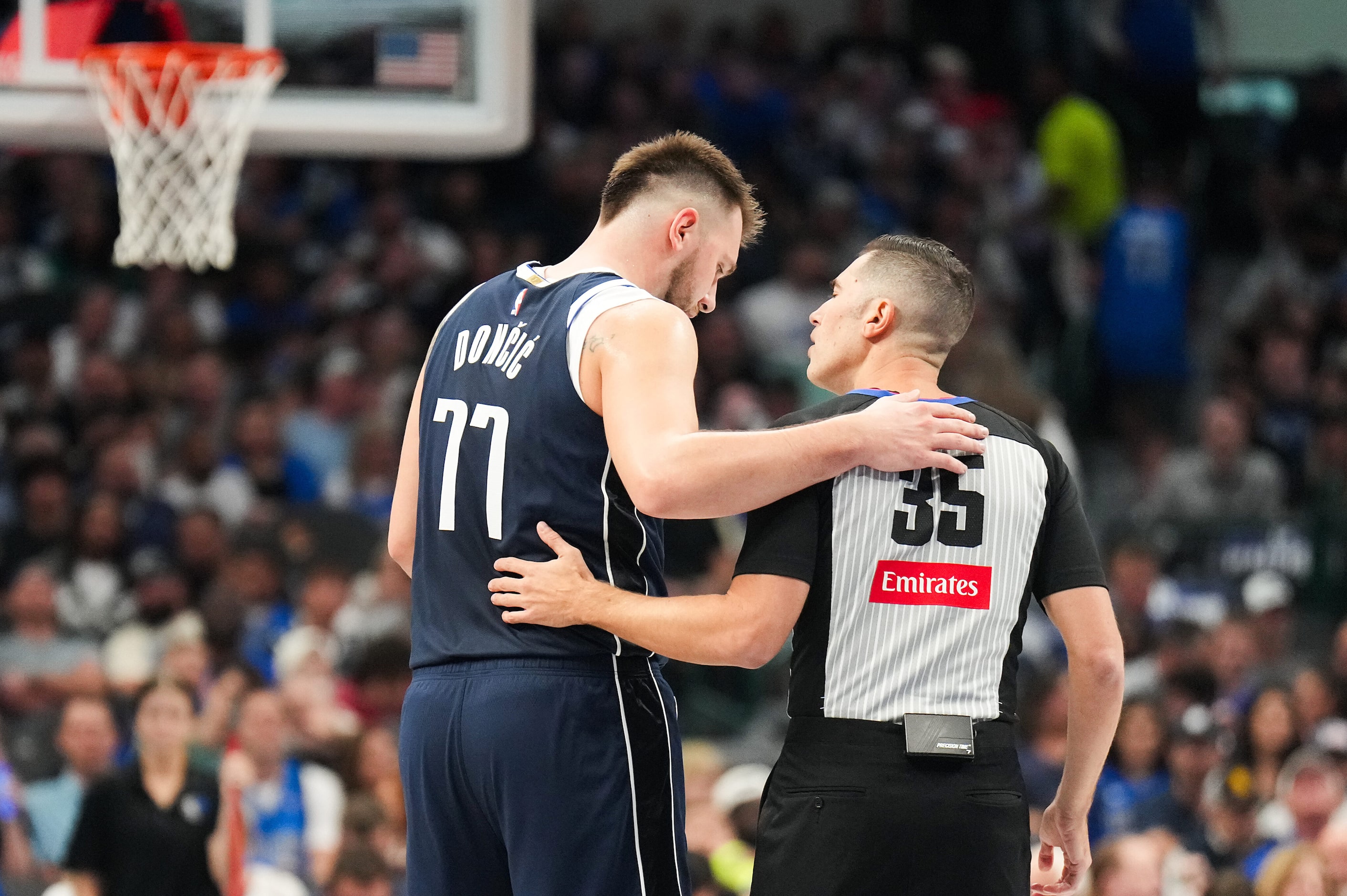 Dallas Mavericks guard Luka Doncic (77) talks with referee Jason Goldenberg (35) during the...