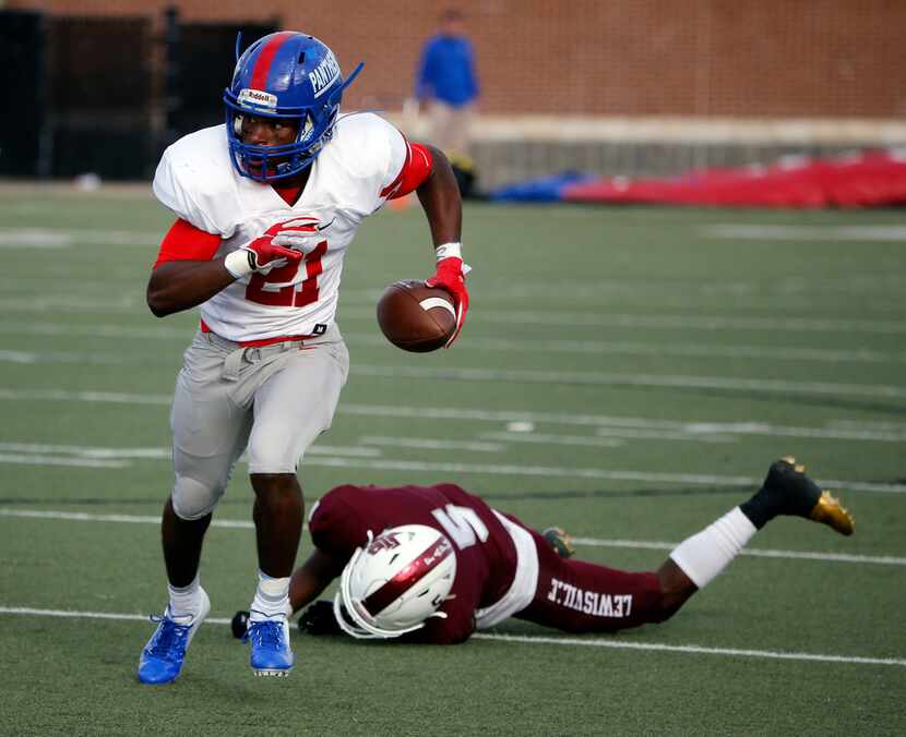 Duncanville's Tre'Shon Devones (21) runs back an interception for a touchdown on a pass...