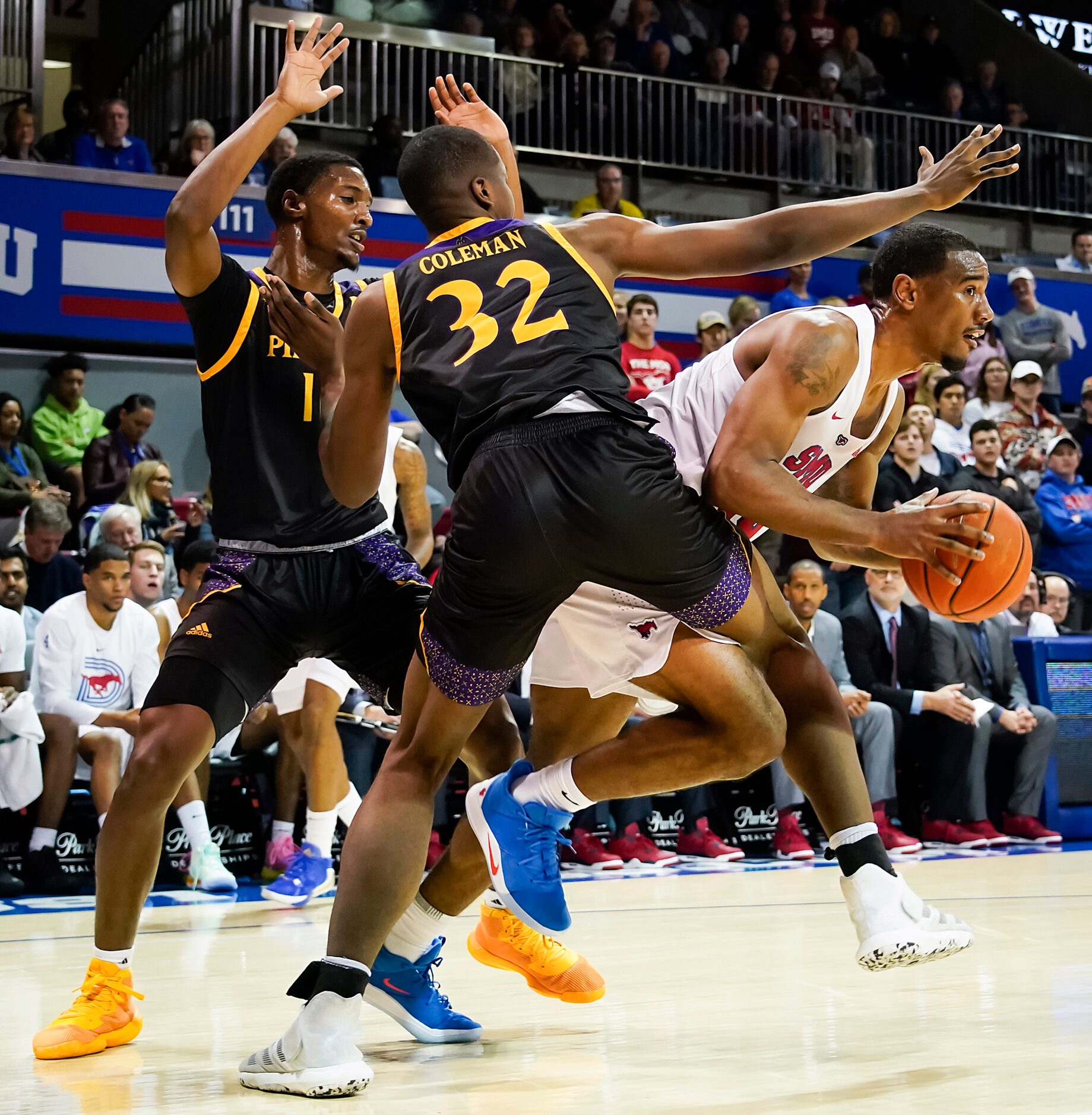 SMU forward Isiaha Mike (15) gets around the trap from East Carolina center Charles Coleman...