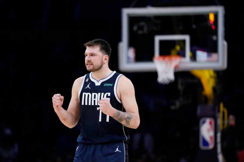 Dallas Mavericks' Luka Doncic (77) reacts to a teammate's basket in the second overtime of...