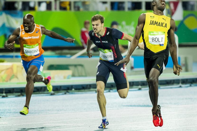 Usain Bolt (right) of Jamaica crosses the finish line ahead of Christophe Lemaitre of France...