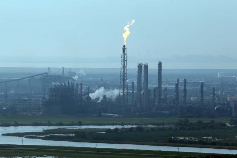 A flare stack puts out a flame at a refinery near an area hit by floodwaters from Tropical...