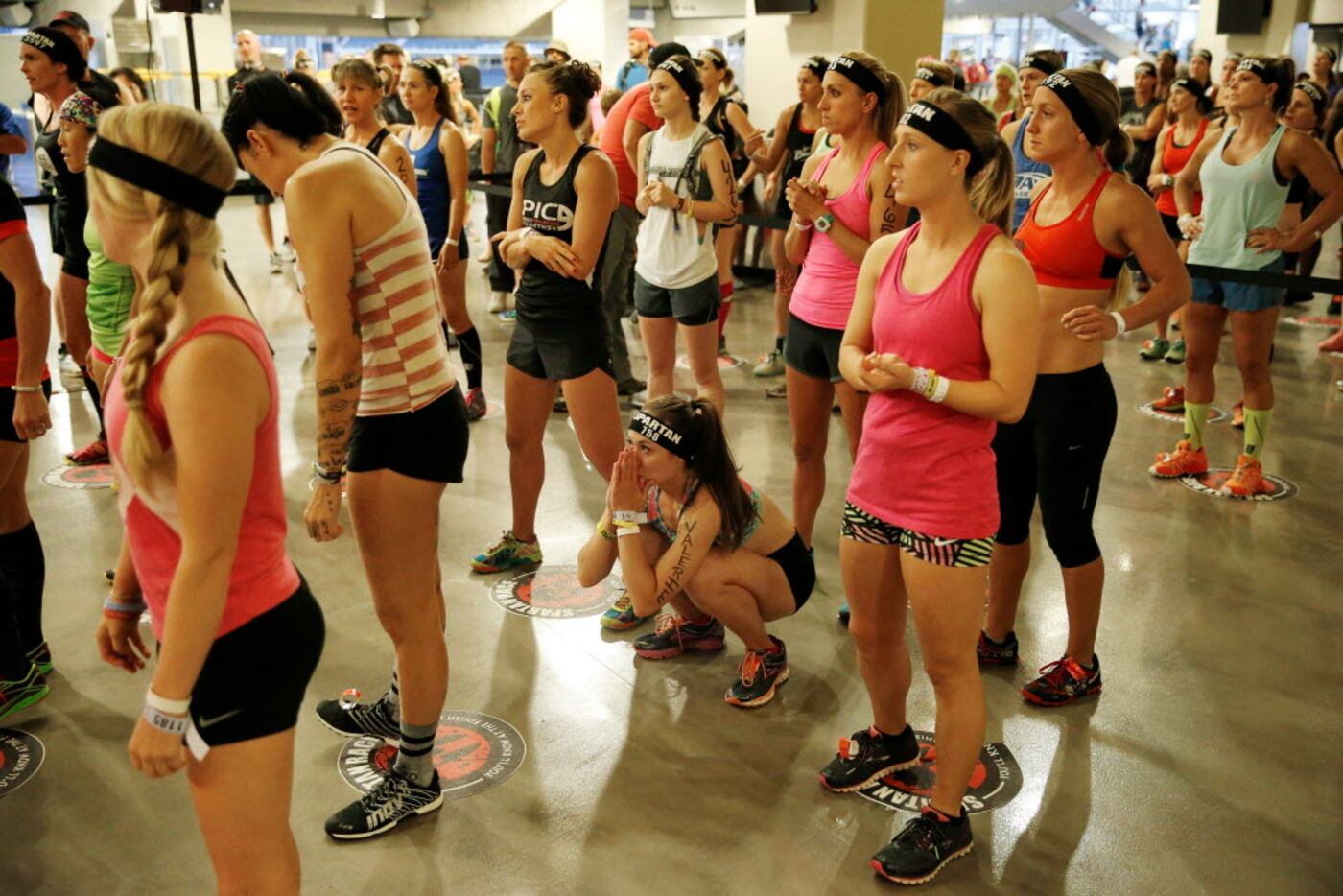 Racers lineup before participating in the Spartan Sprint race inside AT&T Stadium in...