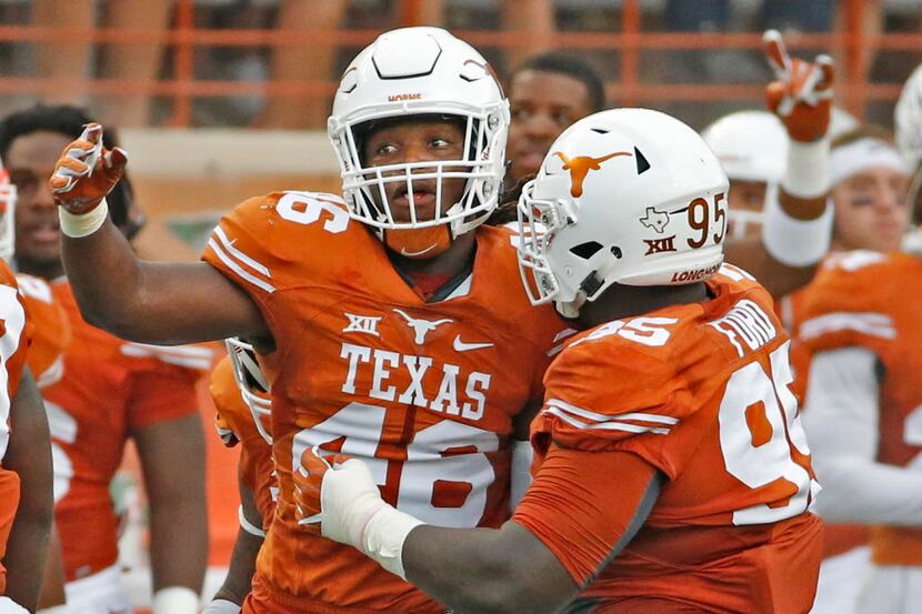 Texas linebacker Malik Jefferson (46) and defensive tackle Poona Ford (95) celebrate a...