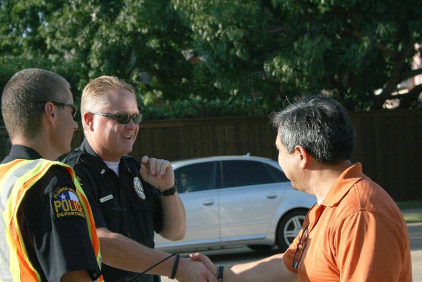 Ernest Sandoval (right) thanks Flower Mound Police Lt. Shane Jennings before walking away...