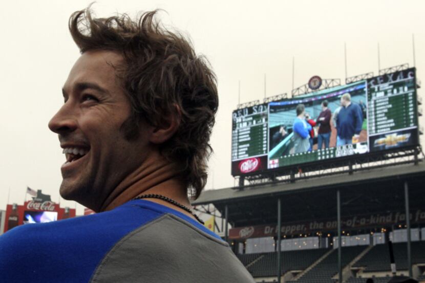 Texas Rangers opening day starting pitcher C.J. Wilson is all smiles as he checks out the...