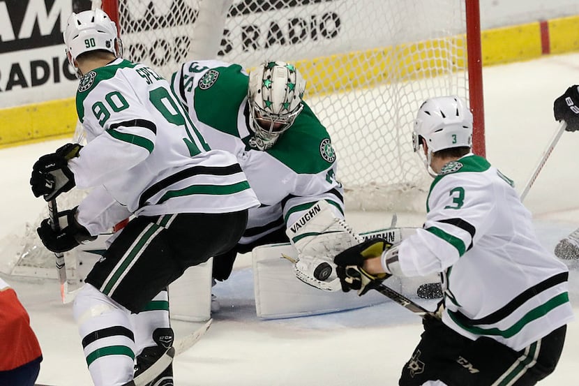 Dallas Stars goaltender Anton Khudobin catches the puck during the third period of an NHL...