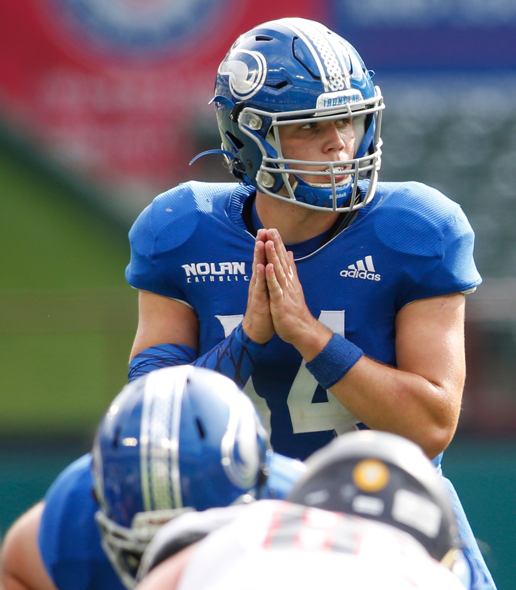 Fort Worth Nolan quarterback Jimmy Taylor (14) looks over the Plano John Paul ll defensive...