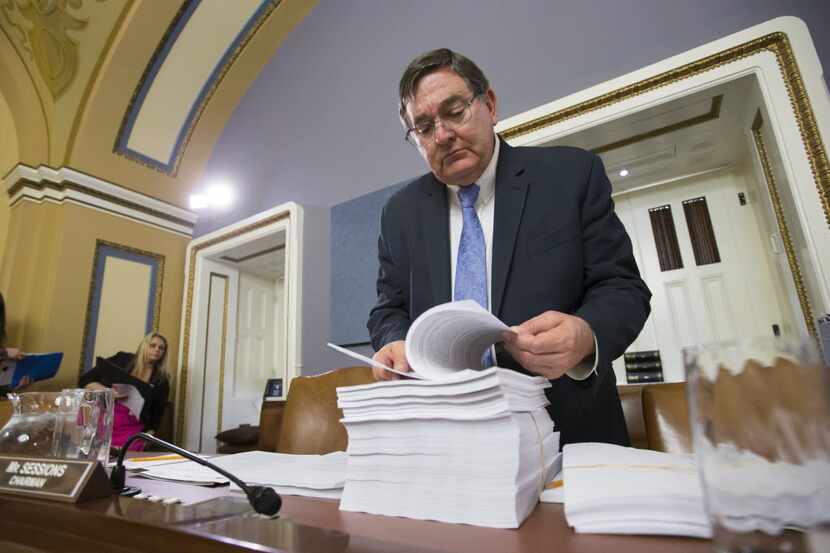 House Rules Committee member Rep. Michael Burgess, R-Pilot Point, examines a printout of the...