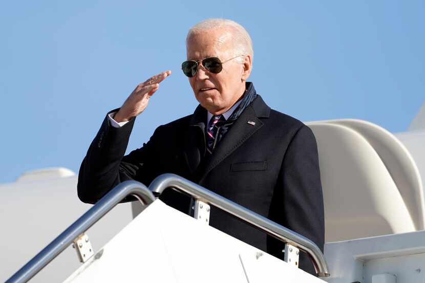 President Joe Biden salutes as he boards Air Force One at Joint Base Andrews in Maryland on...