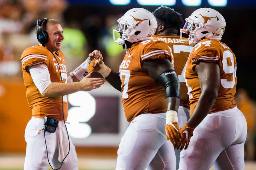 Texas Longhorns quarterback Shane Buechele (7) celebrates with team mates after a touchdown...