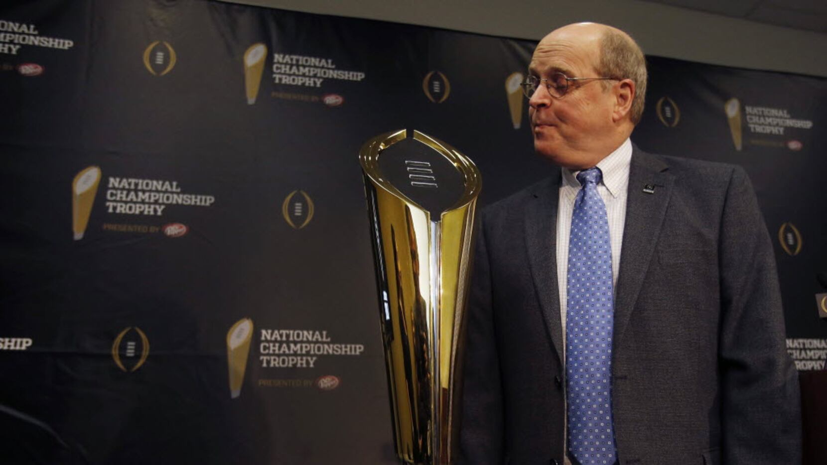 College Football Playoff executive director Bill Hancock poses with the new national...