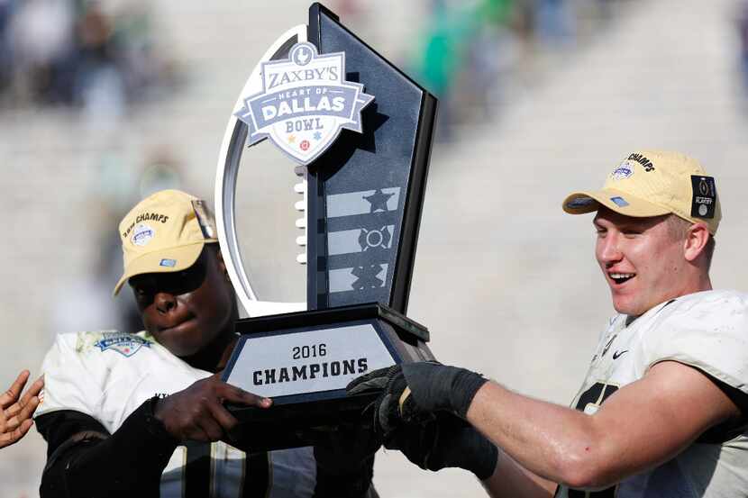 Army hoists up the Heart of Dallas Bowl Trophy at Cotton Bowl Stadium.  Army defeated North...