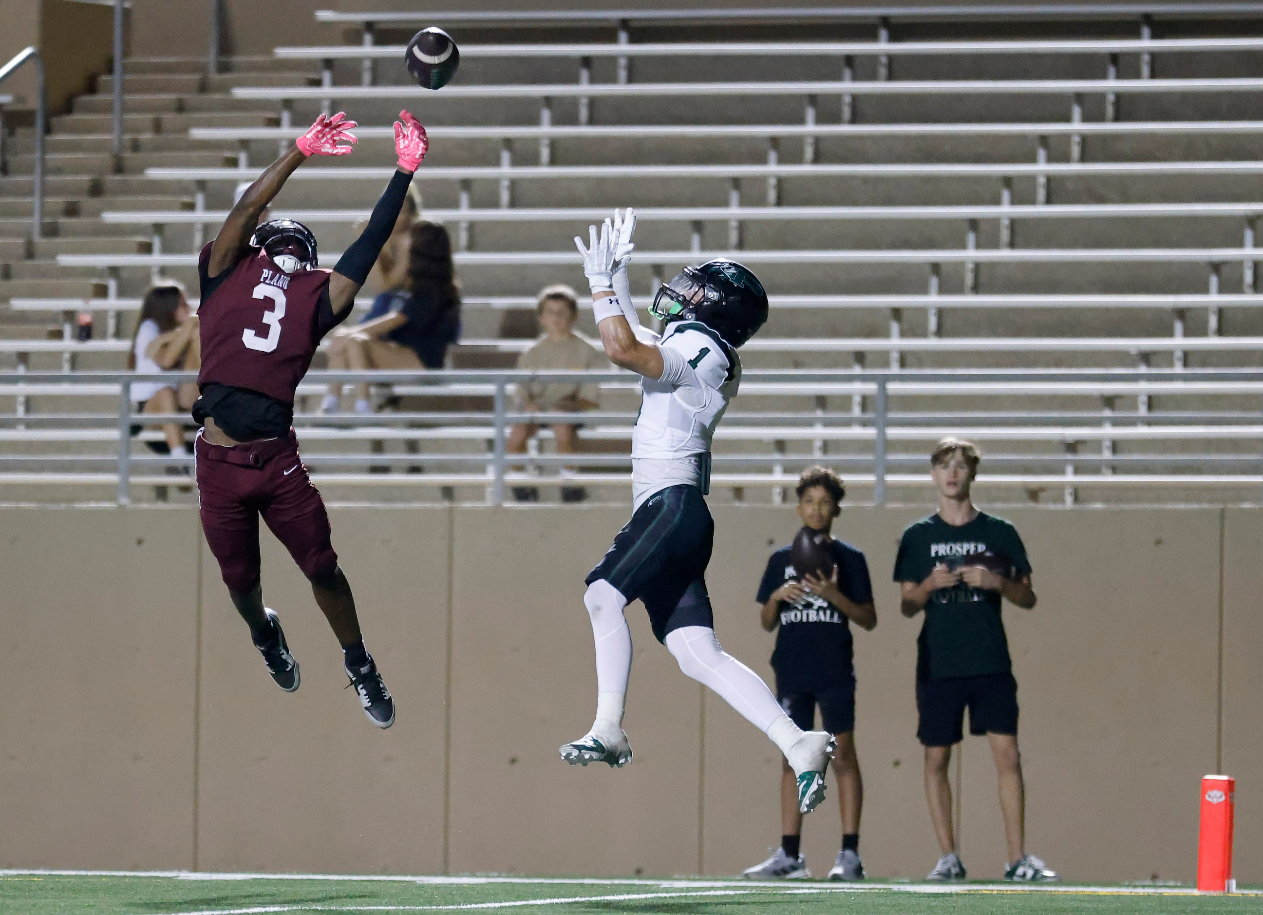 Plano High defensive back DJ Hamilton (3) goes high to tip a would-be touchdown pass to...