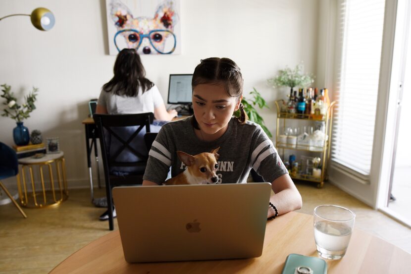 Paul Quinn College freshman Andrea Maldonado, 19, works on her college lessons as her sister...