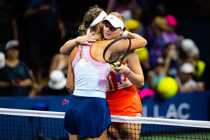Victoria Azarenka of Belarus and Ashlyn Krueger of the United States embrace at the net...