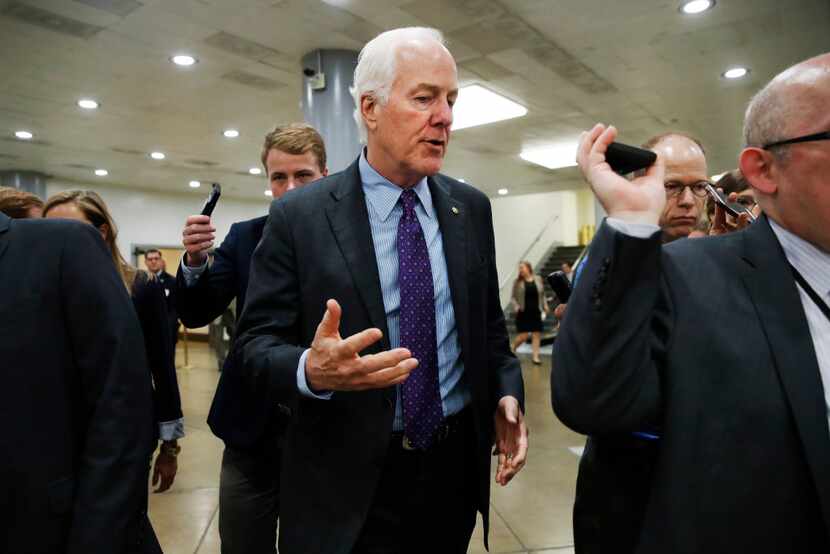 Senate Majority Whip John Cornyn of Texas, center, speaks to reporters on Capitol Hill in...