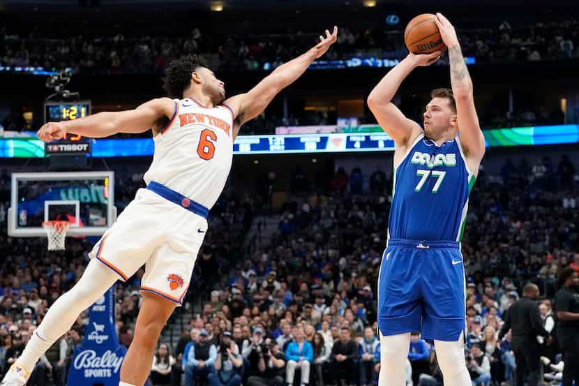 Dallas Mavericks guard Luka Doncic (77) shoots against New York Knicks guard Quentin Grimes...