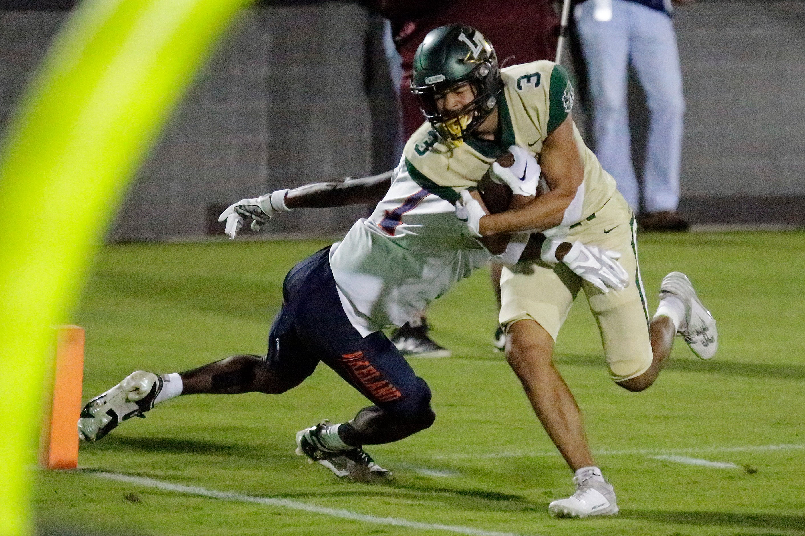 Lebanon Trail High School wide receiver Joaquin Gibson (3) scores a touchdown as Wakealnd...