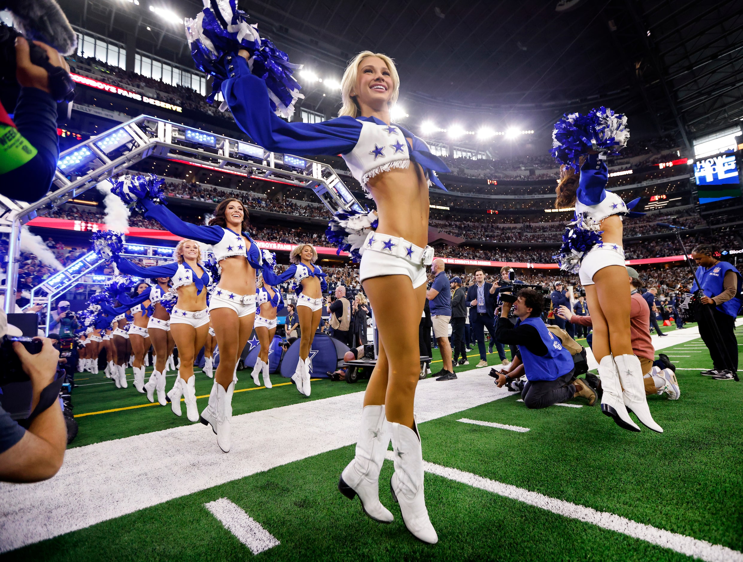 The Dallas Cowboys Cheerleaders skip onto the field during their introduction before the...