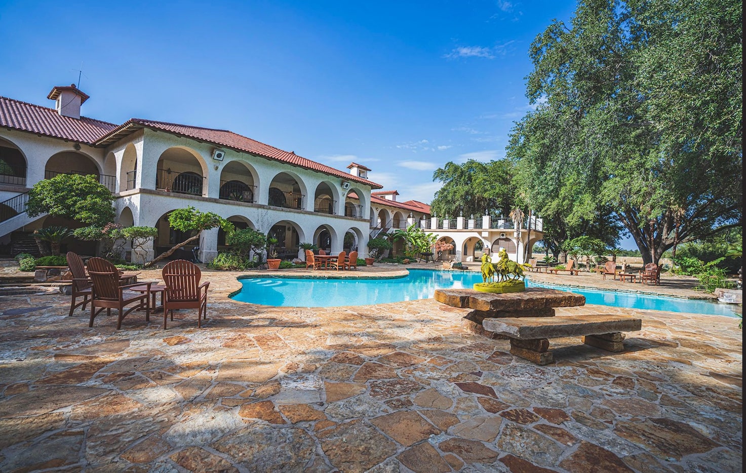 The centerpiece ranch house has a huge pool and outdoor living areas.