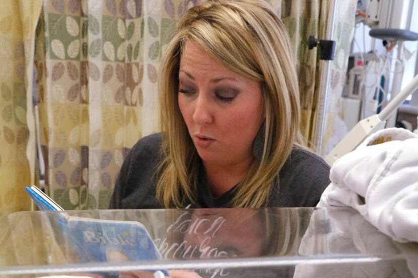 Anna Aguilar reads a book to her son, Cannon Aguilar, who is in the neonatal intensive care...