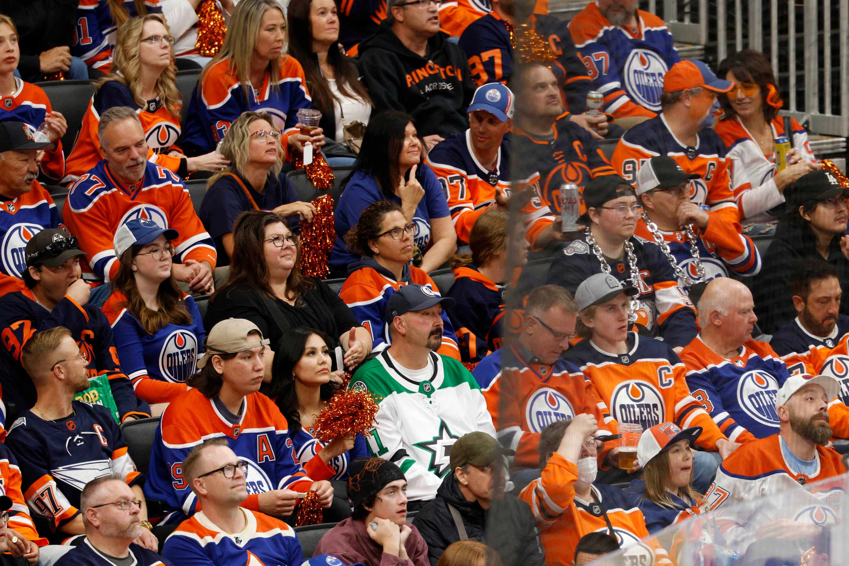 A lone Dallas Stars fan sits amongst a sea of Edmonton Oilers fans during the second period...