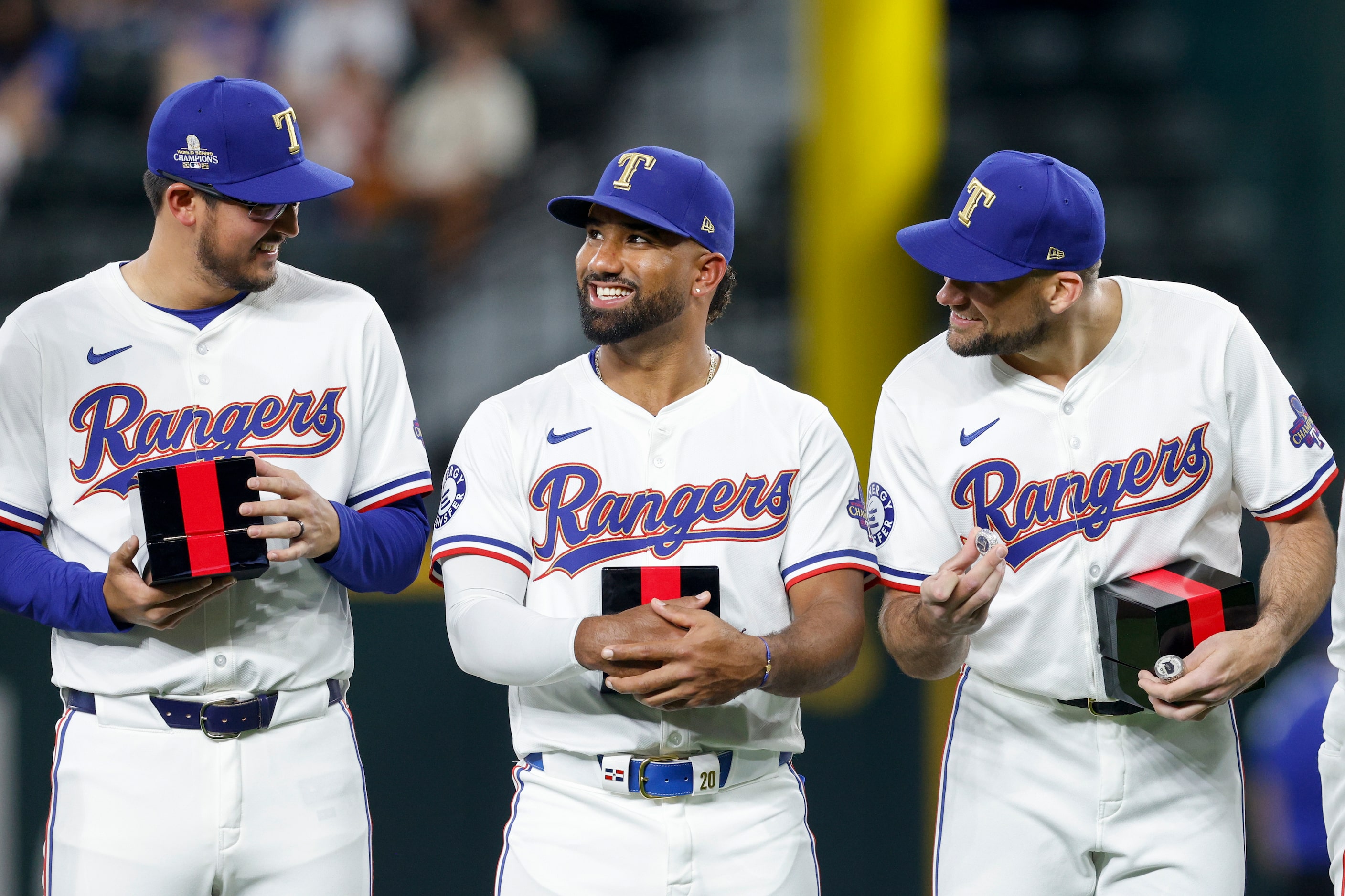 Texas Rangers starting pitcher Dane Dunning (left), first baseman Ezequiel Duran (center)...