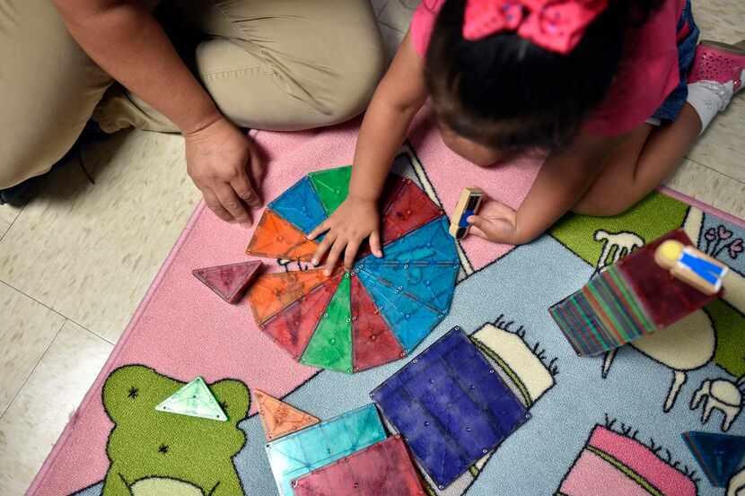Patricia Vega works with daughter Elizabeth Diaz, 3, on educational activities to help her...