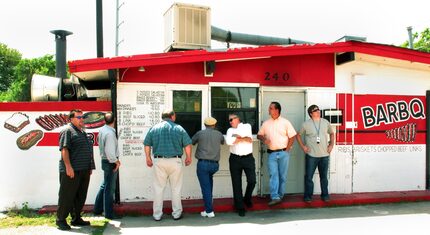 Customers order from the screened window at Meshack's Bar-B-Que Shack in Garland. A DMN...