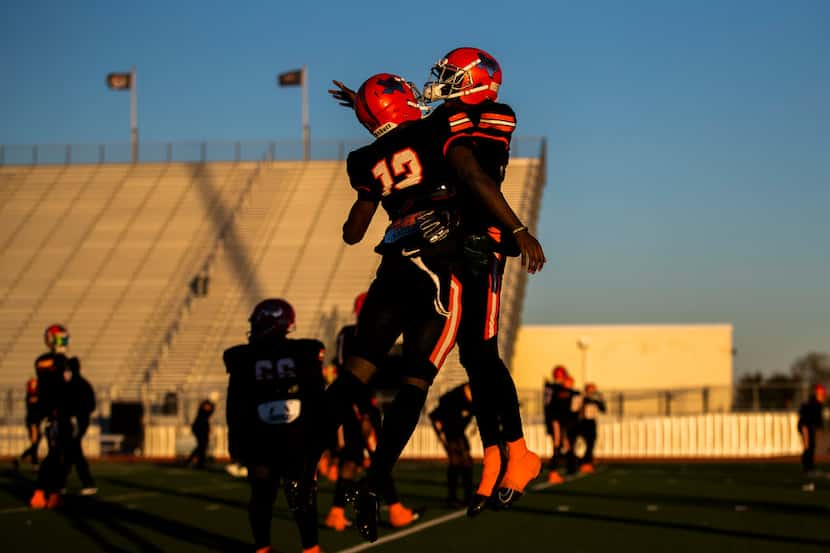 Lancaster defensive back Theron Stropps (13) and running back Desmond Frazier (23) celebrate...