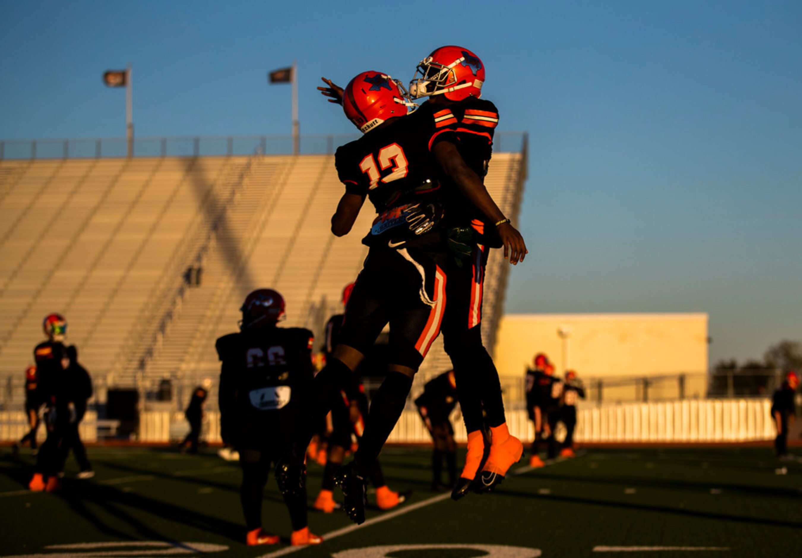 Lancaster defensive back Theron Stropps (13) and running back Desmond Frazier (23) celebrate...